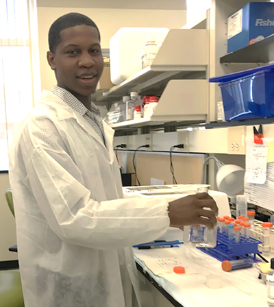 2018 Summer Scholar participant Christopher McCoy, Winston-Salem State University, wearing jacket in lab