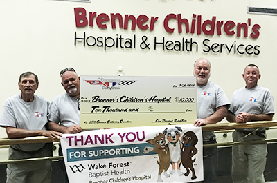 5th Generation Camaros of the Carolinas Club members pose in Brenner Children's with giant check